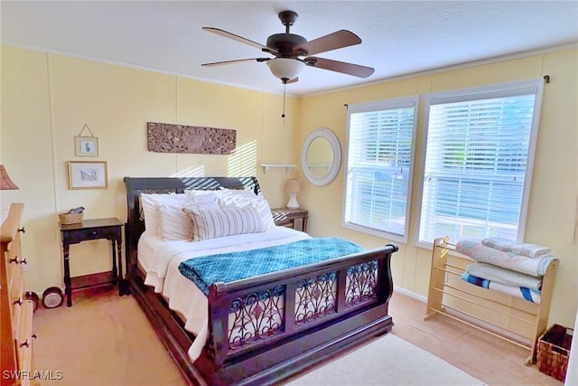 carpeted bedroom with multiple windows and ceiling fan