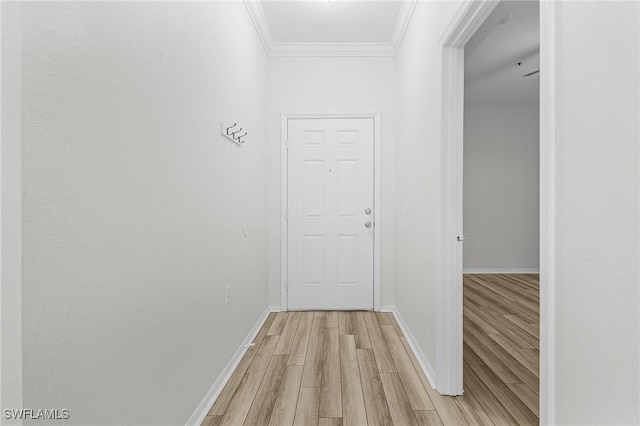 hall with ornamental molding and light hardwood / wood-style flooring