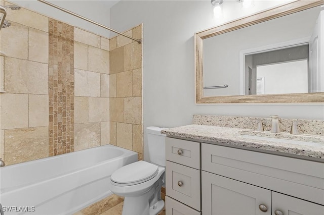 full bathroom featuring vanity, tiled shower / bath combo, and toilet