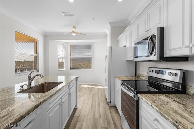 kitchen with white cabinetry, sink, stainless steel appliances, and ornamental molding