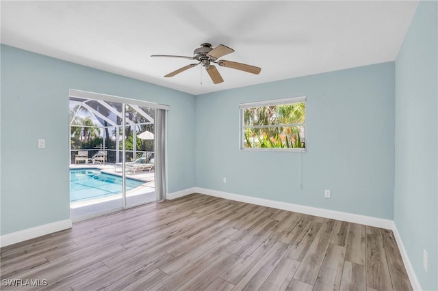 empty room featuring ceiling fan and light hardwood / wood-style floors