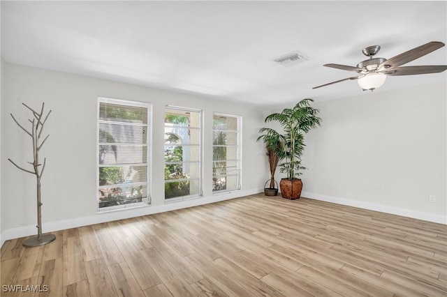 spare room featuring light hardwood / wood-style floors and ceiling fan