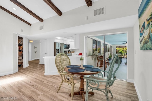 dining area with beam ceiling, ceiling fan, light hardwood / wood-style flooring, and high vaulted ceiling