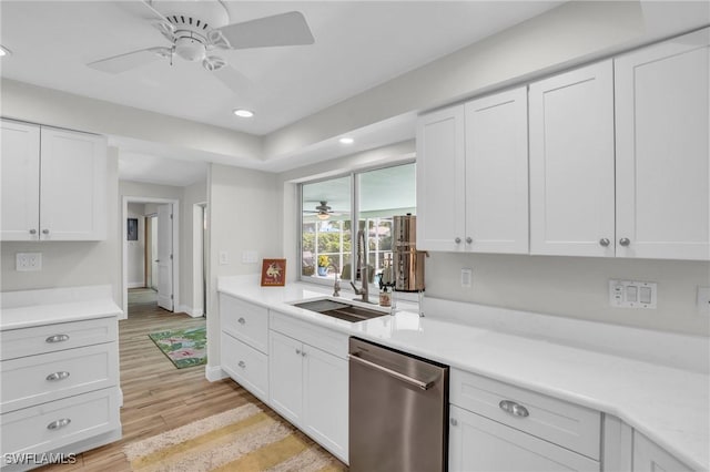 kitchen featuring dishwasher, white cabinets, light hardwood / wood-style flooring, and sink