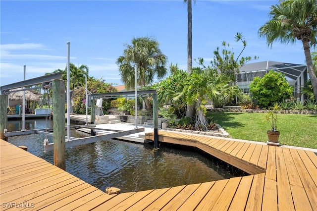 dock area with a yard and a water view