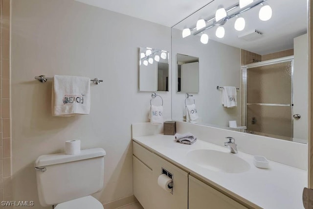 bathroom with vanity, toilet, and walk in shower