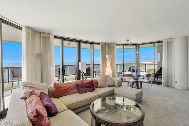 living room with expansive windows, a water view, and carpet floors