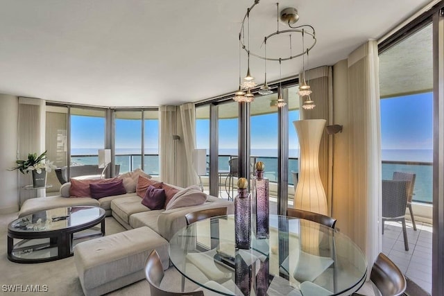 living room with tile patterned flooring, expansive windows, and a water view