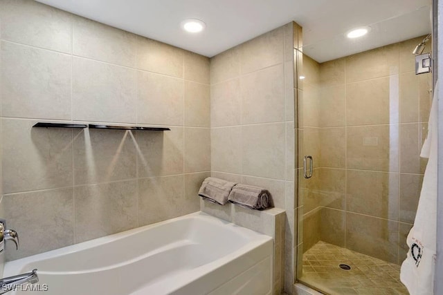 bathroom with shower with separate bathtub