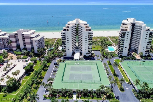 drone / aerial view featuring a water view and a beach view