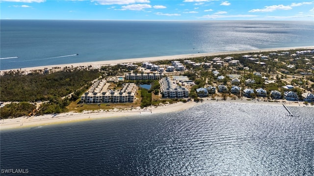 bird's eye view featuring a water view and a beach view