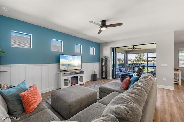 living room with ceiling fan and light wood-type flooring