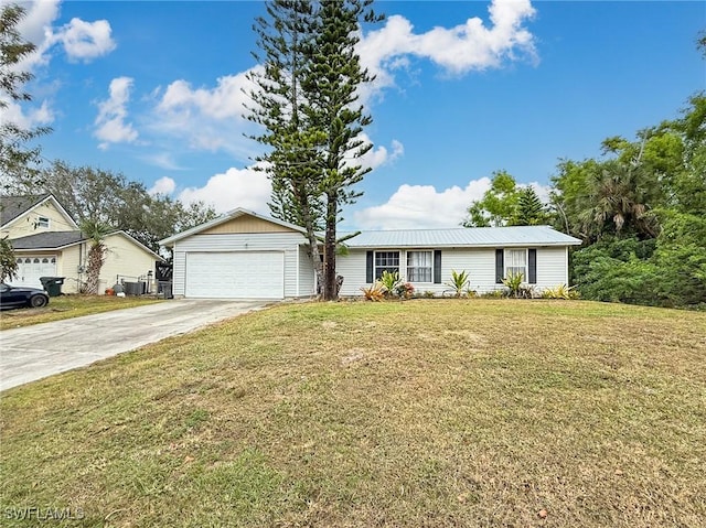 view of front of property featuring a front lawn and a garage