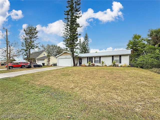 view of front of home with a garage and a front lawn