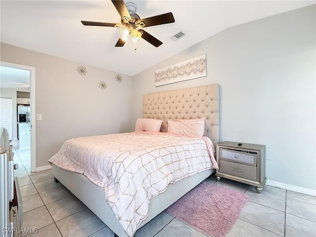 tiled bedroom featuring ceiling fan and vaulted ceiling