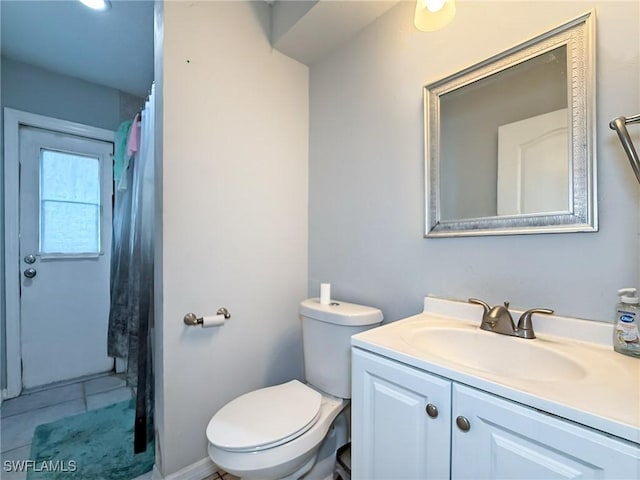 bathroom featuring tile patterned floors, vanity, and toilet