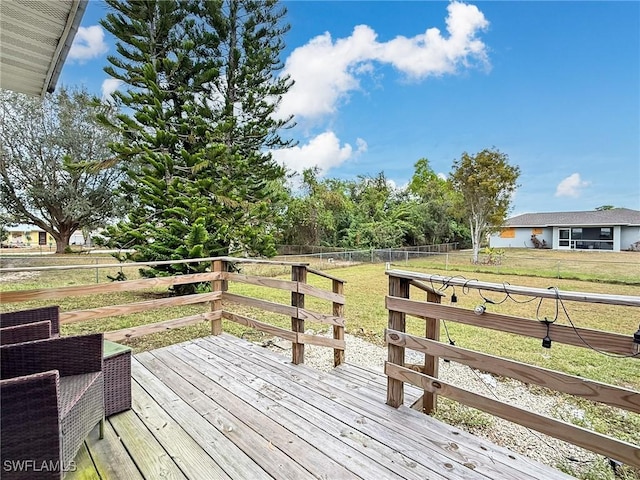 wooden terrace featuring a yard