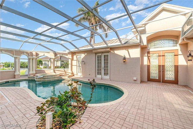 view of swimming pool featuring a lanai, a patio area, an in ground hot tub, and french doors