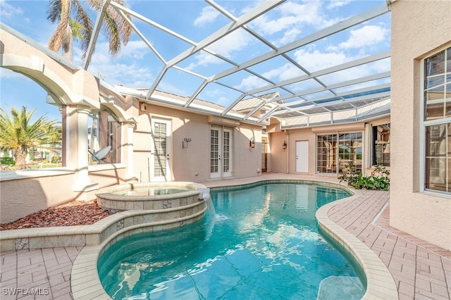 view of swimming pool featuring a lanai, an in ground hot tub, a patio, and french doors