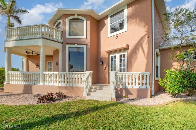 view of front of house featuring a porch, a balcony, and ceiling fan