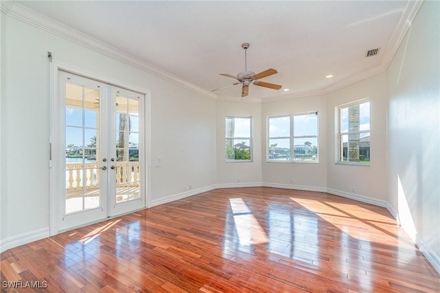 spare room with french doors, light hardwood / wood-style flooring, ceiling fan, and ornamental molding