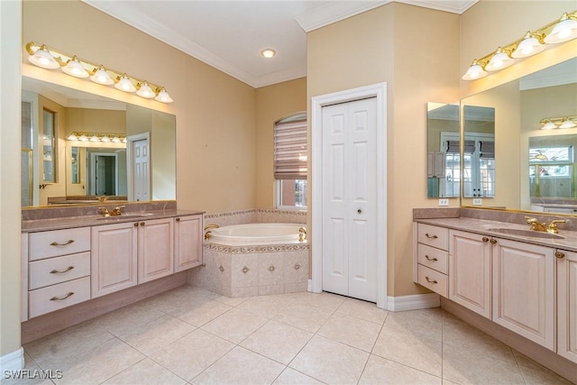 bathroom with vanity, tile patterned floors, crown molding, and tiled tub