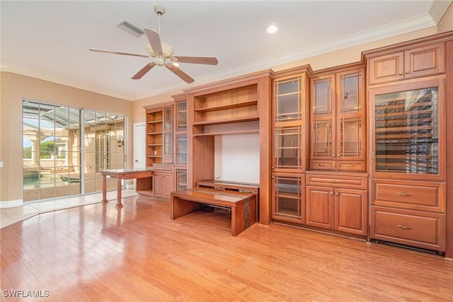 unfurnished office with light hardwood / wood-style floors, ceiling fan, and crown molding