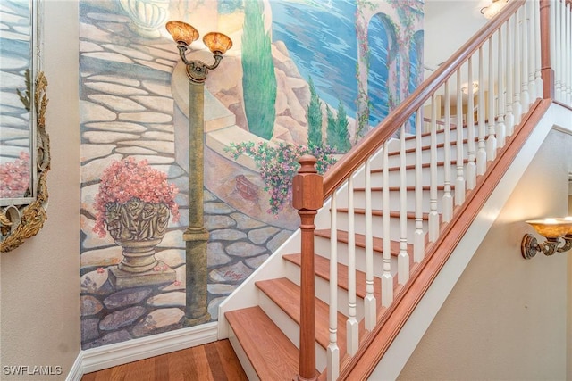 stairs featuring hardwood / wood-style floors