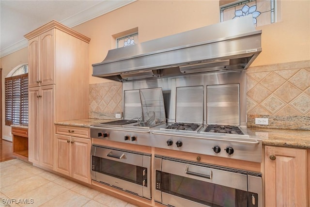 kitchen featuring decorative backsplash, ornamental molding, extractor fan, light brown cabinets, and stainless steel gas stovetop