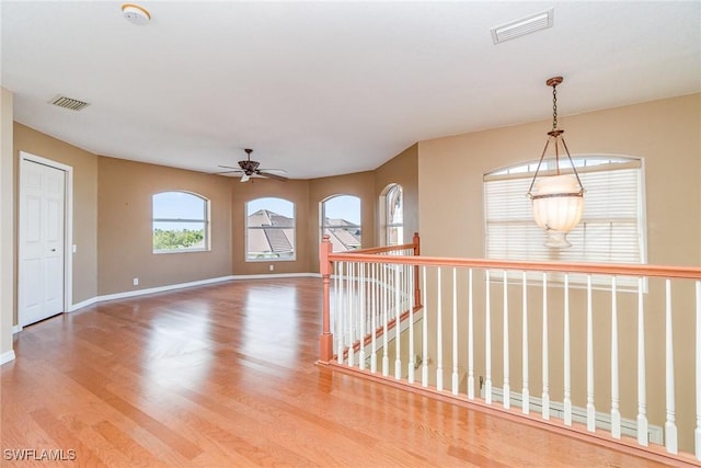 spare room with wood-type flooring and ceiling fan