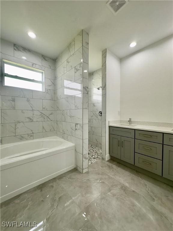 bathroom featuring vanity and shower with separate bathtub