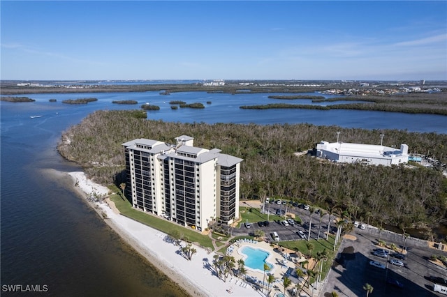 drone / aerial view featuring a beach view and a water view