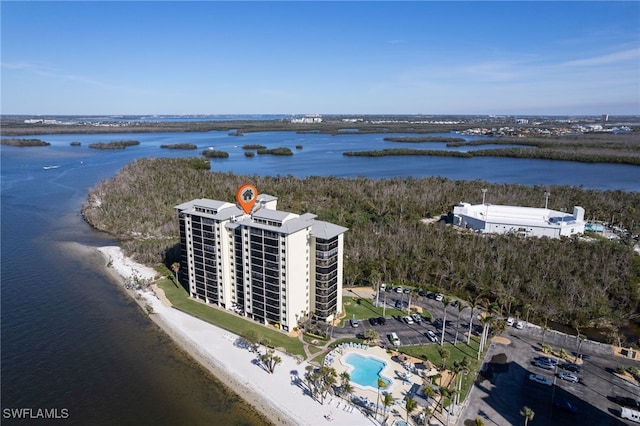 drone / aerial view with a water view and a view of the beach