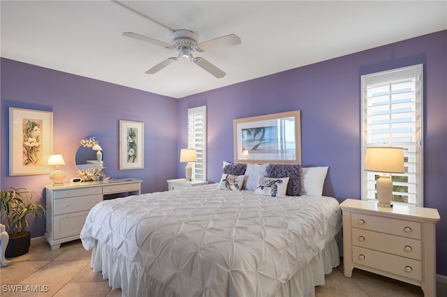 bedroom with ceiling fan and light tile patterned flooring