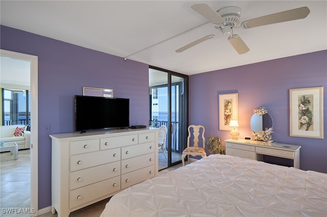 bedroom featuring ceiling fan, expansive windows, light tile patterned floors, and multiple windows