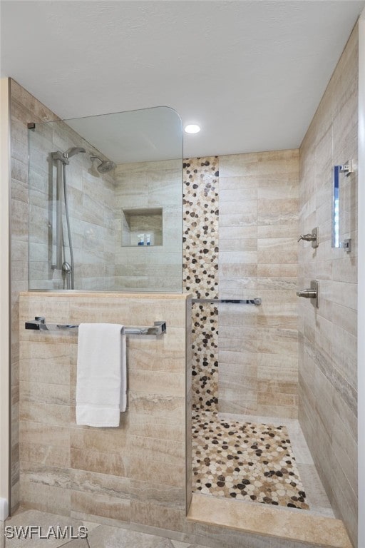 bathroom featuring a tile shower