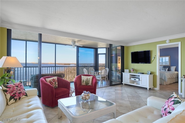 tiled living room with ceiling fan, floor to ceiling windows, a water view, and crown molding