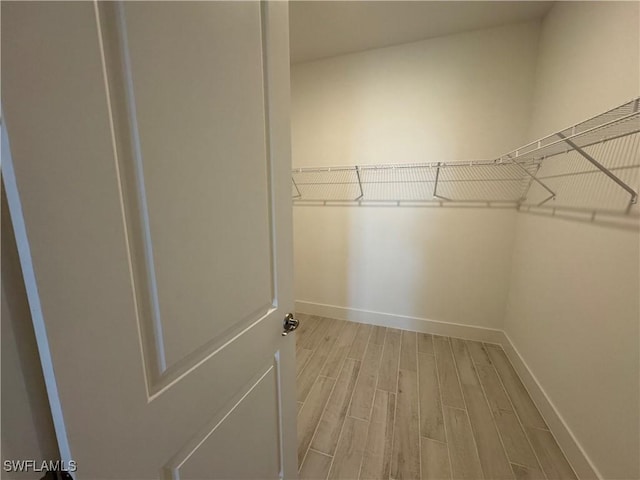 spacious closet with light wood-style floors