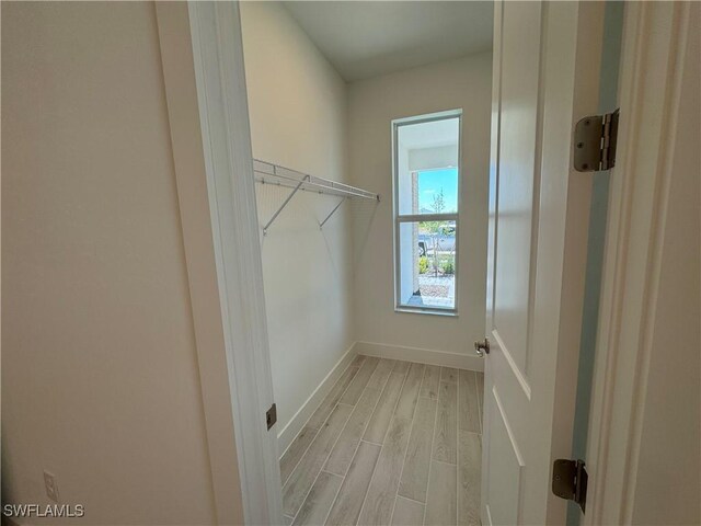 walk in closet featuring light wood finished floors