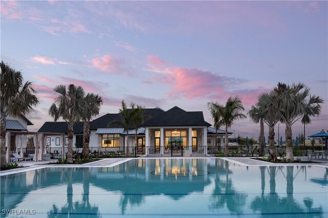 community pool featuring fence and a patio