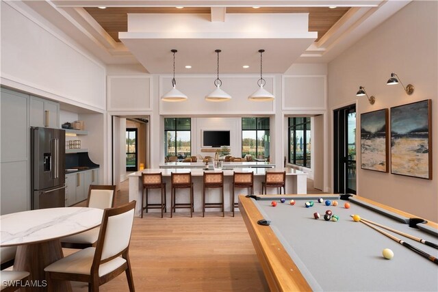 game room with light wood finished floors, billiards, a high ceiling, and recessed lighting