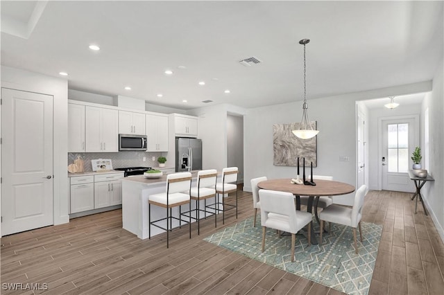 44283 Panther Dr, Punta Gorda, FL 33982 - dining room with light wood-type flooring, baseboards, and recessed lighting