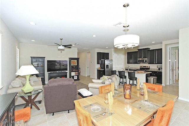 dining area with ceiling fan and light tile patterned floors