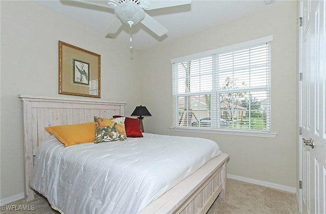 bedroom with ceiling fan and light carpet