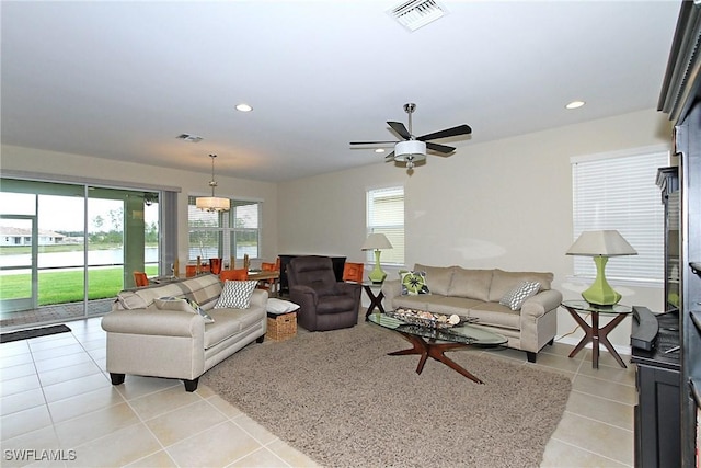 living room with ceiling fan and light tile patterned flooring