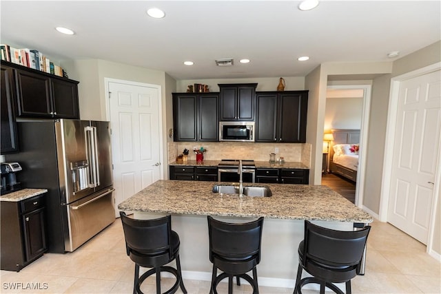 4147 Dutchess Park Rd, Fort Myers, FL 33916 - kitchen featuring stainless steel appliances, decorative backsplash, a breakfast bar area, and recessed lighting