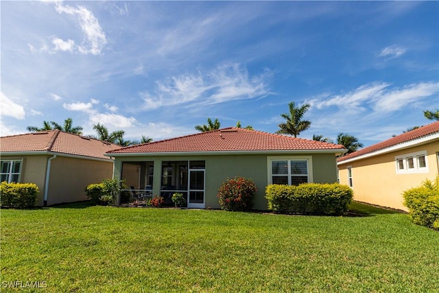 4147 Dutchess Park Rd, Fort Myers, FL 33916 - back of property featuring a tiled roof, stucco siding, a yard, and a sunroom