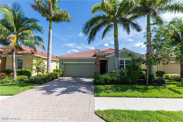 4147 Dutchess Park Rd, Fort Myers, FL 33916 - view of front of property with stucco siding, a garage, a tiled roof, and decorative driveway