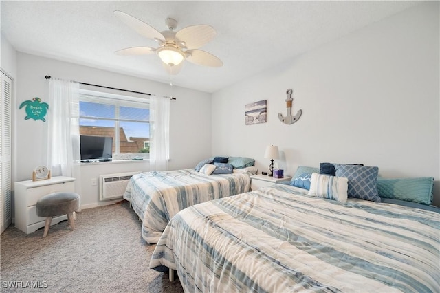 bedroom featuring carpet flooring, a closet, a wall unit AC, and ceiling fan