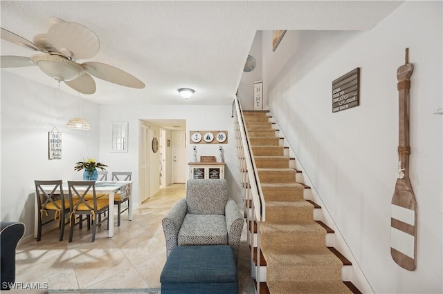 stairway with ceiling fan